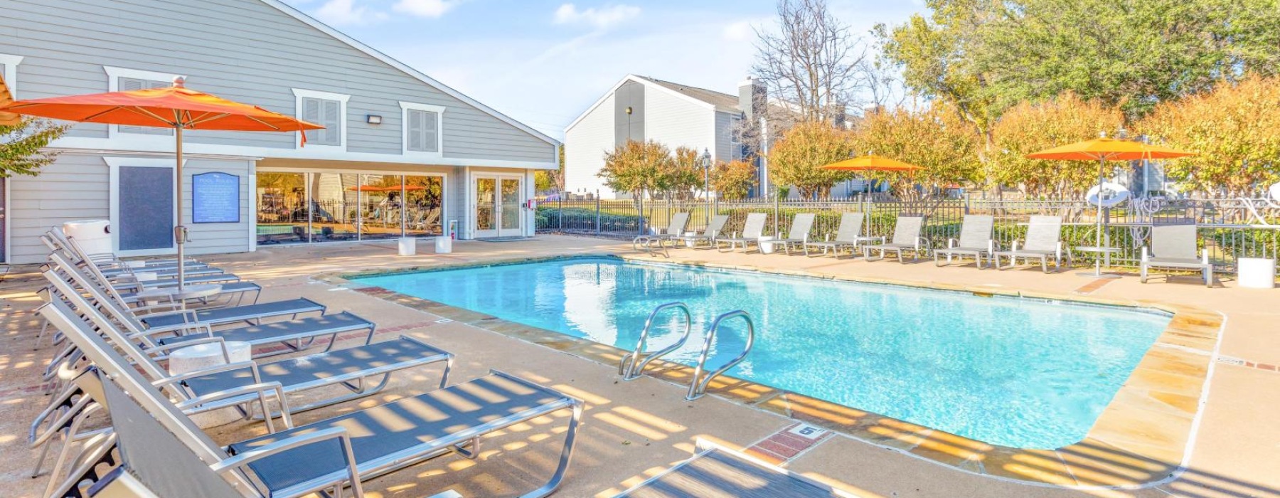 a swimming pool with lounge chairs around it